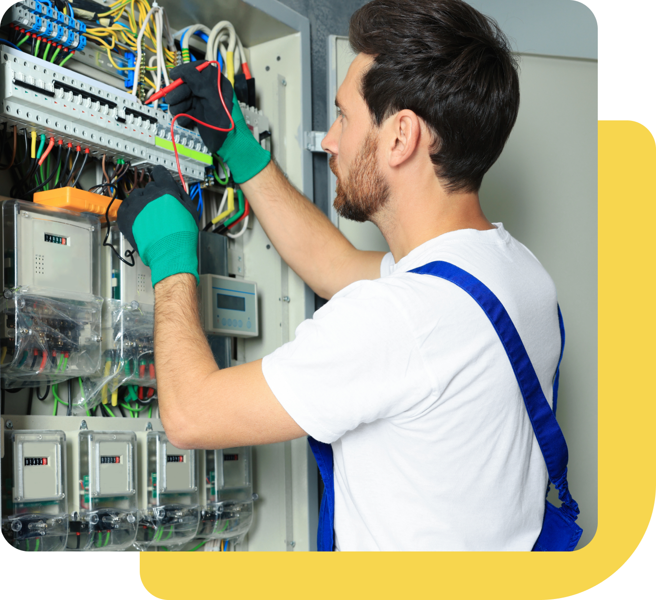 Group 656 A man working on electrical equipment in an industrial setting.