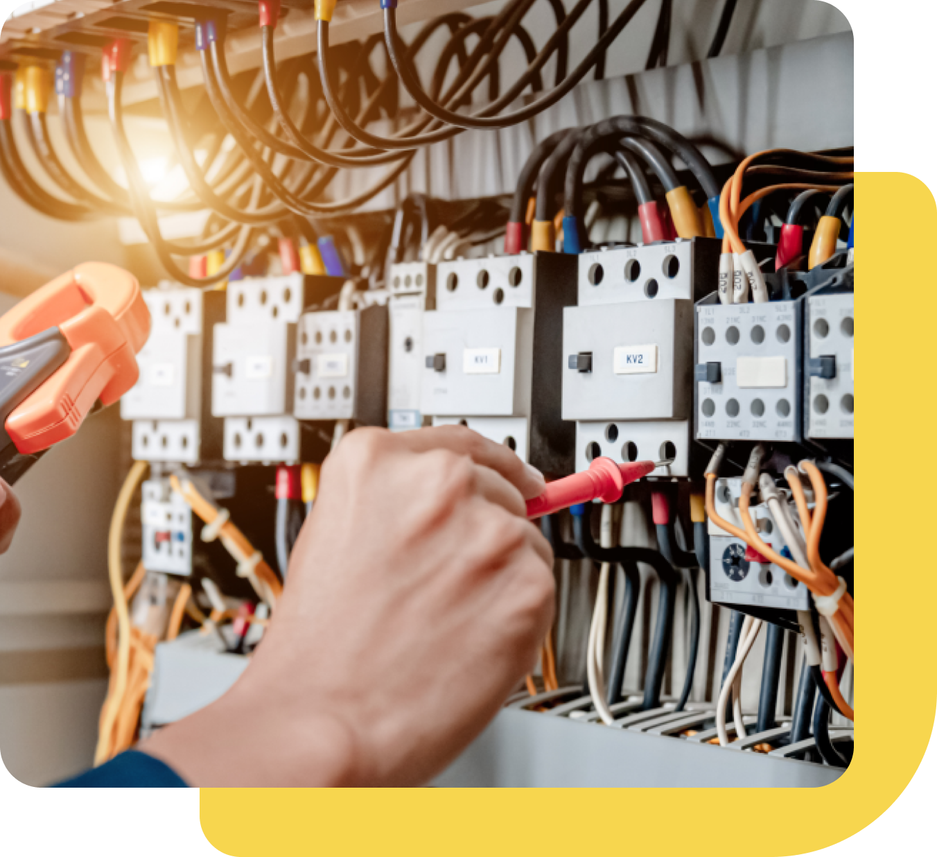Group 657 A person is working on electrical wiring in an industrial setting.