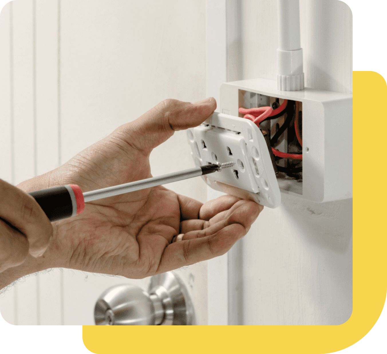 Group 658 A person is holding a screwdriver and fixing an electrical outlet.